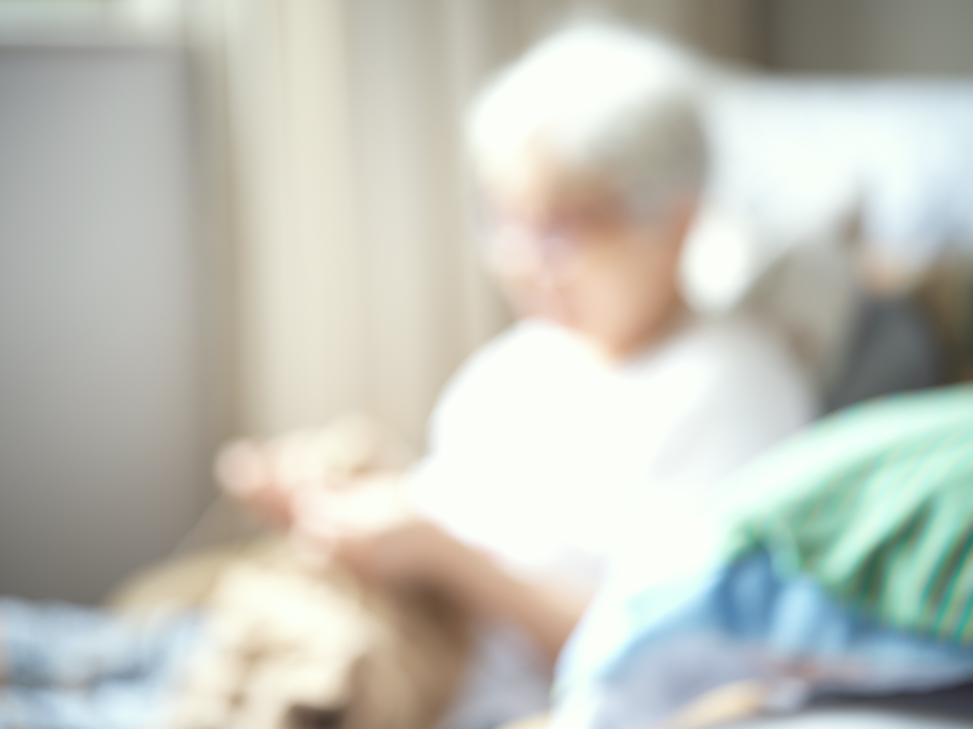 An elderly figure dissolving into bright, blurred light